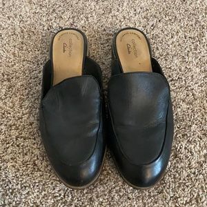 Clarks black leather mules.